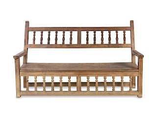 A Peruvian Colonial Hardwood Bench
Height 38 1/2 x width 64 3/4 x depth 21 inches.