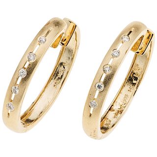 A yellow gold 14 K pair of hoops with diamonds.