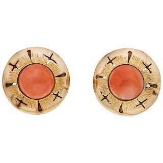 A yellow gold 14 K pair of earrings with corals.