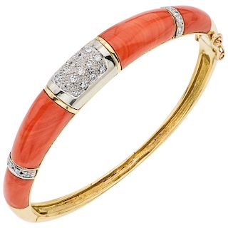 A yellow gold 18 K bracelet with corals and diamonds.