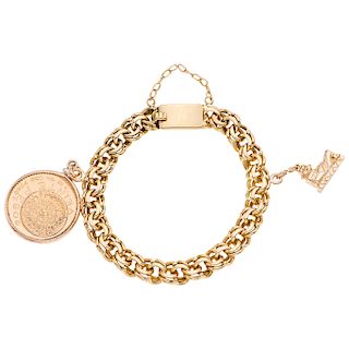 A yellow gold 21. 6 K, 18 K and 14 K bracelet with demonetized  coin and pendant.