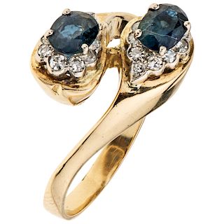 A yellow gold 14 K diamond ring with sapphires.