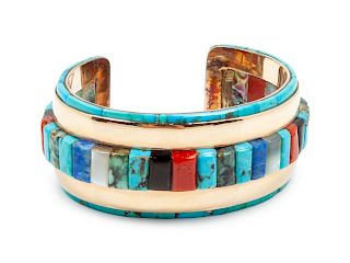 Ben Nighhorse Campbell
(Cheyenne, b. 1933)
Yellow gold cuff bracelet with turquoise, coral, jet, shell, and lapis mosaic inlay
 