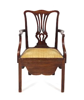 A Chippendale Carved and Figured Mahogany Convenience Armchair