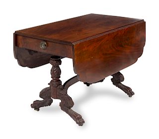 A Classical Carved and Figured Mahogany Drop-Leaf Table