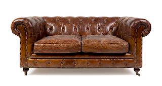 A Leather Upholstered Chesterfield Sofa
Height 41 x width 70 x depth 39 inches.