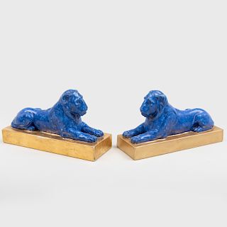 Pair of Continental Porcelain Faux Marble Lions on Gilt Bases