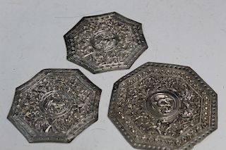 Three Chinese metal plaques.