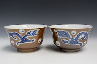 Two Chinese brown glaze dragon bowls.