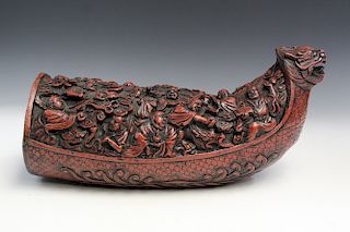 Chinese carved bamboo root of a dragon boat with 18 luohans.