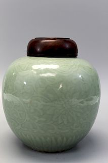 Chinese celadon porcelain jar with wood lid.