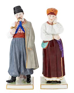 A PAIR OF RUSSIAN PORCELAIN FIGURINES OF A UKRAINIAN MAN AND WOMAN, POPOV PORCELAIN FACTORY, GORBUNOVO, 1810S-1860S