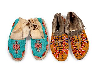 Two Pairs of Northern Plains Beaded Hide Moccasins
lengths 10 1/2 and 9 1/2 inches