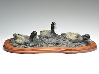 Bronze sculpture of three swimming bluebills, Wiliam Turner.
