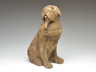 Wooden carving of a dog.