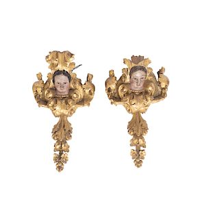 A PAIR OF MOUNTING BRACKETS. MEXICO, CIRCA 1900. Wooden and polychromed sculptures with gilded details. 30 in tall.