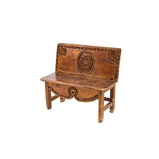 BENCH. MEXICO, LATE 19TH CENTURY. Carved wood, decored with scrolls, fleur-de-lys and crown of thorns in the center.