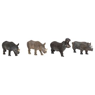 GROUP OF MINIATURE RHINOCEROS AND HIPPOPOTAMUS. FIRST HALF OF THE 20TH CENTURY. Hand painted bronze. Four pieces. 4 in tall. 