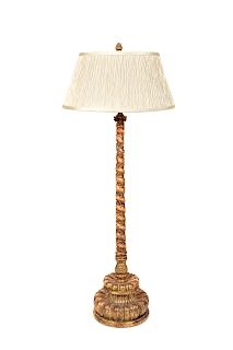 An Italian Carved and Parcel Giltwood Table Lamp
Height 42 1/2 inches.