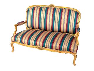 A Louis XV Style Giltwood Settee 
Height 42 x length 61 x depth 30 inches.