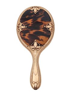 An English Art Nouveau 9K Gold and Tortoise Mounted Hand Mirror
Length 10 1/2 inches.