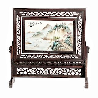Framed Chinese landscape painted on porcelain.