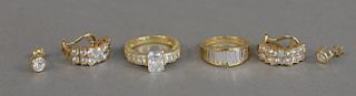 14K gold lot to include two rings and two pairs of earrings, all mounted with cubic zirconias, 18 total grams.