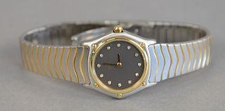 Ebel womans wave gold steel and diamond wristwatch having gold bezel with black dials and diamond markers.