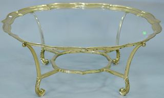 Brass trimmed glass coffee table. ht. 16 1/2 in., dia. 41 in.