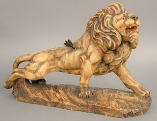 Large marble figure of a lion with arrow in its side, marked made in Italy. ht. 13 in., lg. 20 in.