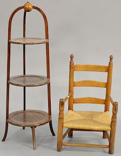 Two piece lot to include primitive child's ladder back armchair, ht. 23 in. and three tier mahogany stand, ht. 36 in.