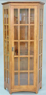 Stickley oak corner cabinet with four glass shelves. ht. 79 in.