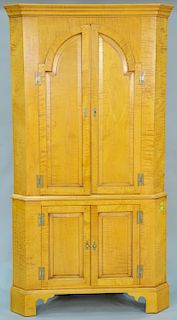Eldred Wheeler tiger maple two part corner cupboard with two doors over twoo doors on bracket base. ht. 82 in., wd. 42 in.