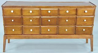 Fifteen drawer spice cabinet set on base. ht. 33 in., wd. 62 in.