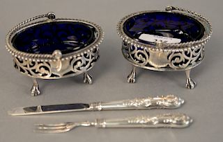 Lot to include pair of English silver salts with ball and claw feet, handles, and cobalt liners along with silver child's knife and fork in fitted cas