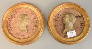Pair of rouge marble plaques mounted with marble busts each with wood frames, one plaque cracked). dia. 7 3/4 in.
