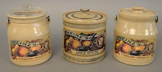 Set of three Heinz stoneware crocks to include two strawberry preserve and an apple butter. ht. 6 in, 6 1/2 in., 6 1/2 in.