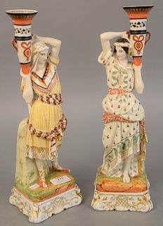 Pair of porcelain figural candlesticks, Eastern man and woman holding an urn, 19th century, drilled for table lamp.