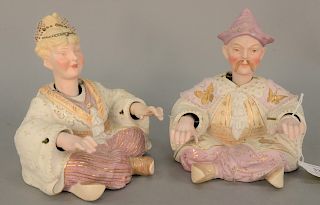 Porcelain male and female nodder figures, polychrome and gilt painted. ht. 5 3/4 in