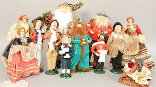 Group of twelve figures to include six Byers choice Christmas Carolers, two santa figures and four Spanish dolls.