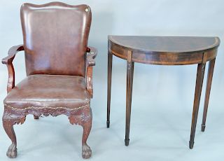 Two piece lot to include Chippendale style mahogany armchair with leather seat and back on hairy claw feet along with mahogany inlaid demilune table.
