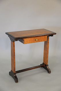 An English yew wood writing table and oval mirror with banded top over a single drawer, on trestle supports, late 19th/20th century. table ht. 28 in.,