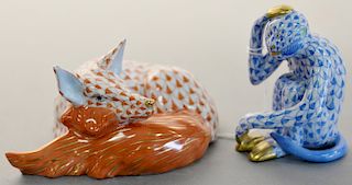 Two Herend porcelain figurines including a sleeping fox in iron red fishnet (ht. 2 1/4 in.) and a blue fishnet gold gilt monkey (ht. 2 3/4 in.). Prove