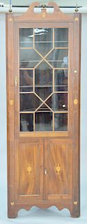 Custom mahogany inlaid corner cabinet having roken arch top over 1 glass door over two doors. ht. 89 in., wd. 31 in.