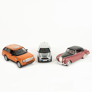 Lote de autos a escala. Consta de: a) Mini Cooper Clubman S 2007, Gris/Plata, Kyosho, 1:18 b) Range Rover Sport 2006. Piezas: 3