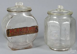 Two clear glass Planters Peanut counter jars, early 20th c., 12'' h. and 13'' h.