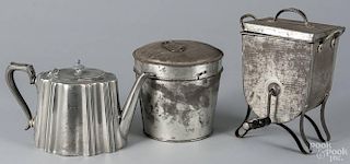 Tin and pewter kitchenwares, 19th c., to include molds, a sifter, etc.