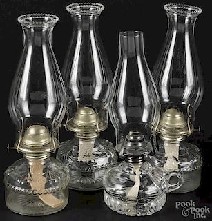 Four glass kerosene lamps, late 19th c., 12 1/2'' h.