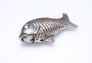 AN UNUSUAL WHITE METAL VESTA CASE, IN THE FORM OF A FISH, 1