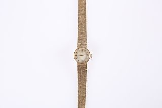 A LADY'S 9ct GOLD OMEGA WRISTWATCH, on a 9ct gold bark effe